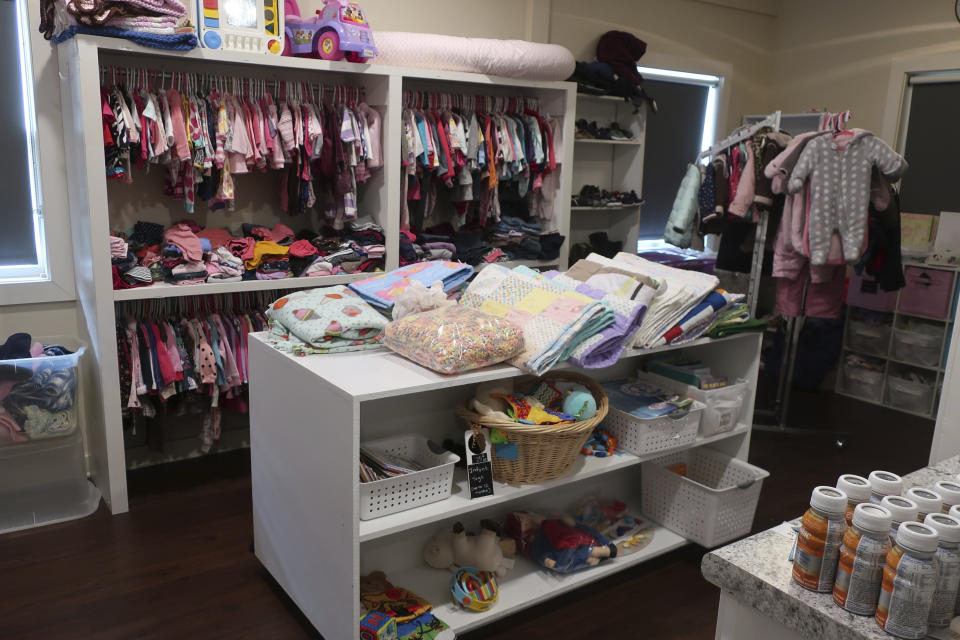 Items are displayed in the "Boutique" at the Insight Women's Center, where clients can find clothes and other supplies for their babies, Tuesday, Jan. 31, 2023, in Lawrence, Kan. The Kansas Legislature is considering providing support to centers that are operated by abortion opponents to help encourage women to carry their pregnancies to term while providing them with services such as parenting classes. (AP Photo/John Hanna)