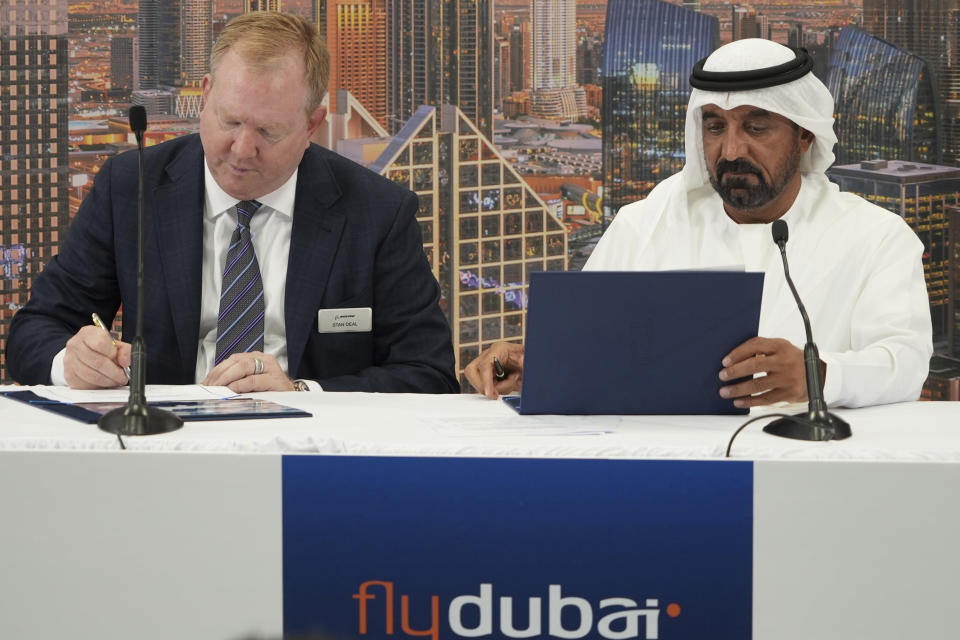 Boeing Co. Vice President Stan Deal, left, and Emirates CEO and Chairman Sheikh Ahmed bin Saeed Al Maktoum, sign a deal for 30 Boeing 787-9 Dreamliners for low-cost carrier FlyDubai at the Dubai Air Show in Dubai, United Arab Emirates, Monday, Nov. 13, 2023. Long-haul carrier Emirates opened the Dubai Air Show with a $52 billion purchase of Boeing Co. aircraft, showing how aviation has bounced back after the groundings of the coronavirus pandemic, even as Israel's war with Hamas clouds regional security. (AP Photo/Lujain Jo)
