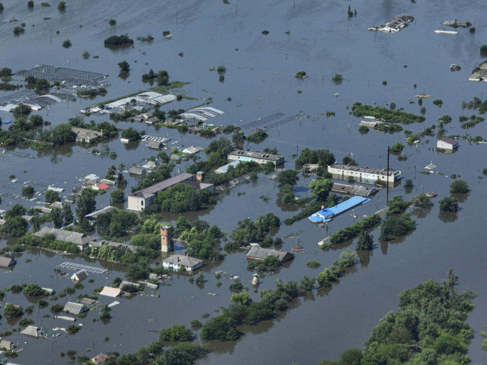 CAPTION CORRECTS LOCATION - Houses are seen underwater in the flooded village of Dnipryany, in Russian-occupied Ukraine, Wednesday, June 7, 2023, after the collapse of Kakhovka Dam. (AP Photo)