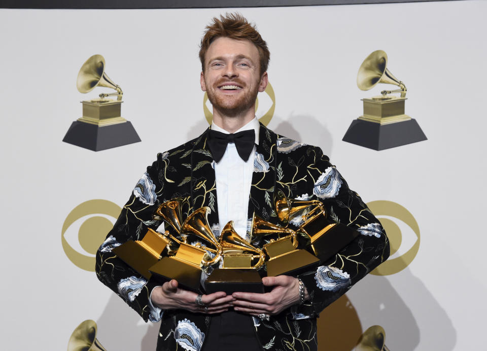 Finneas O'Connell poses in the press room with the awards for best song and best record for "Bad Guy," album of the year and best engineered album, non-classical for "When We All Fall Asleep, Where Do We Go?," and Producer of the Year, Non Classical at the 62nd annual Grammy Awards at the Staples Center on Sunday, Jan. 26, 2020, in Los Angeles. (AP Photo/Chris Pizzello)