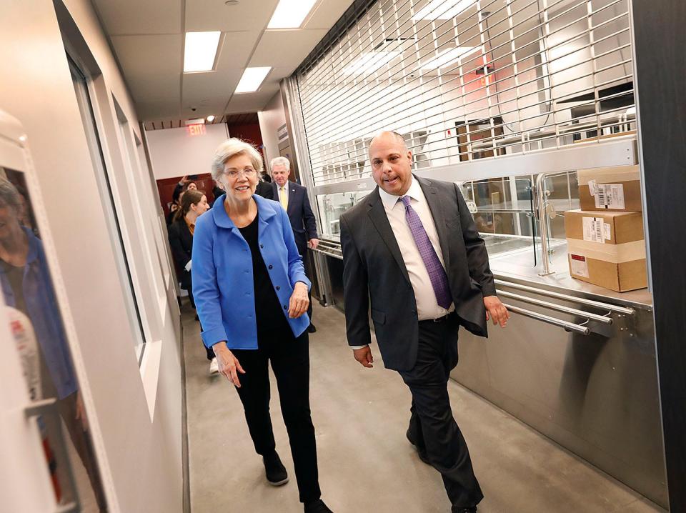U.S. Sen. Elizabeth Warren tours the Yawkey Housing Resource Center's kitchen and dining area with Father Bill's CEO John Yazwinski on Wednesday, August 2, 2023.