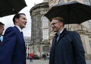 German Bundesbank President Jens Weidmann (R) greets Britain's Chancellor of the Exchequer, George Osborne, for an welcome event in front of the Frauenkirche cathedral in Dresden, Germany, May 27, 2015. Dresden hosts the G7 finance ministers and central bankers meeting. REUTERS/Fabrizio Bensch
