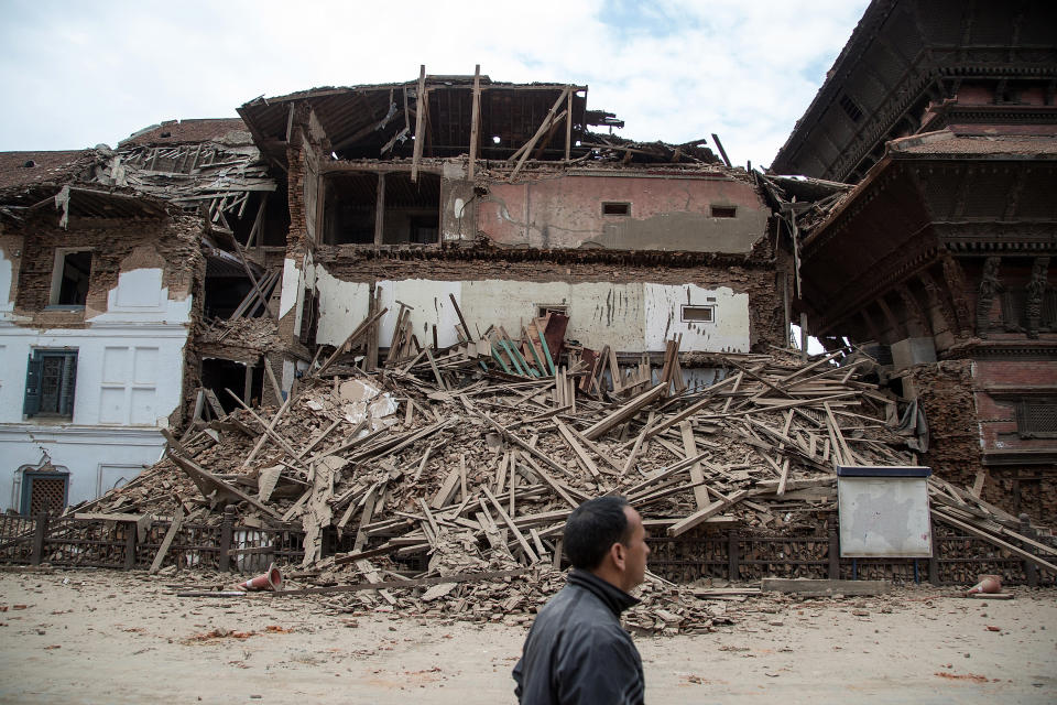 A Kathmandu resident passes in front of a collapsed temple at Basantapur Durbar Square on April 25, 2015, in Kathmandu, Nepal. (Omar Havana/Getty Images)