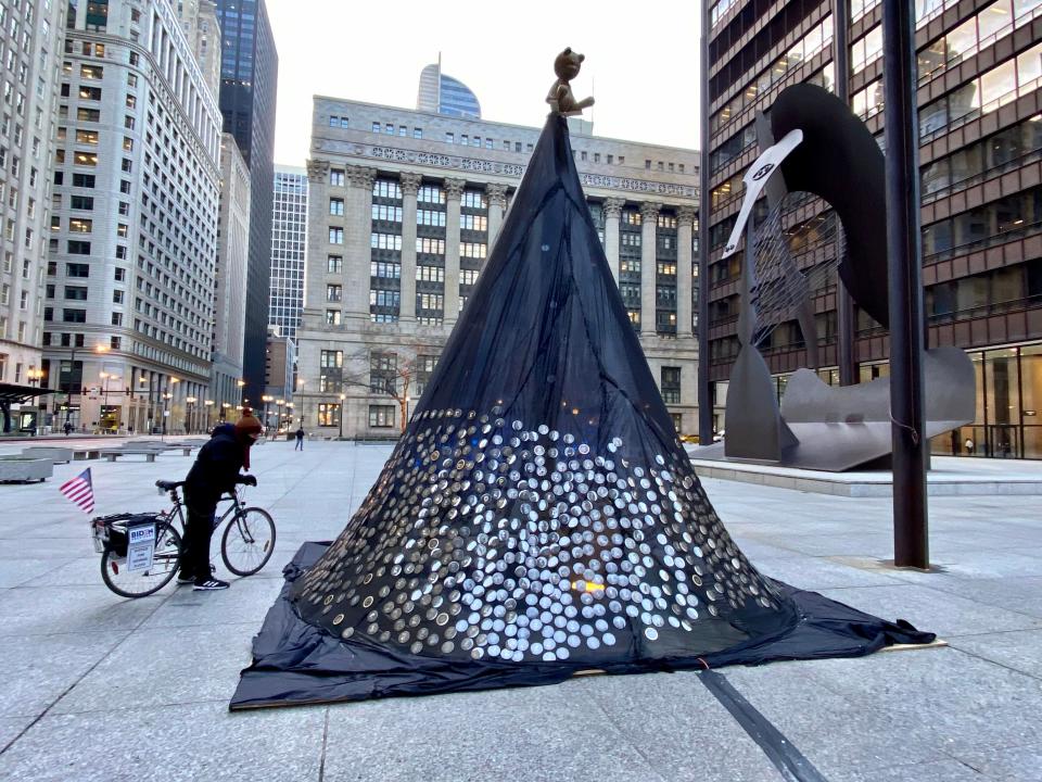 Ornaments bearing the names and images of Chicagoans killed in gun violence hang on the Tree of Remembrance at Daley Plaza in Chicago on Dec. 14, 2020.