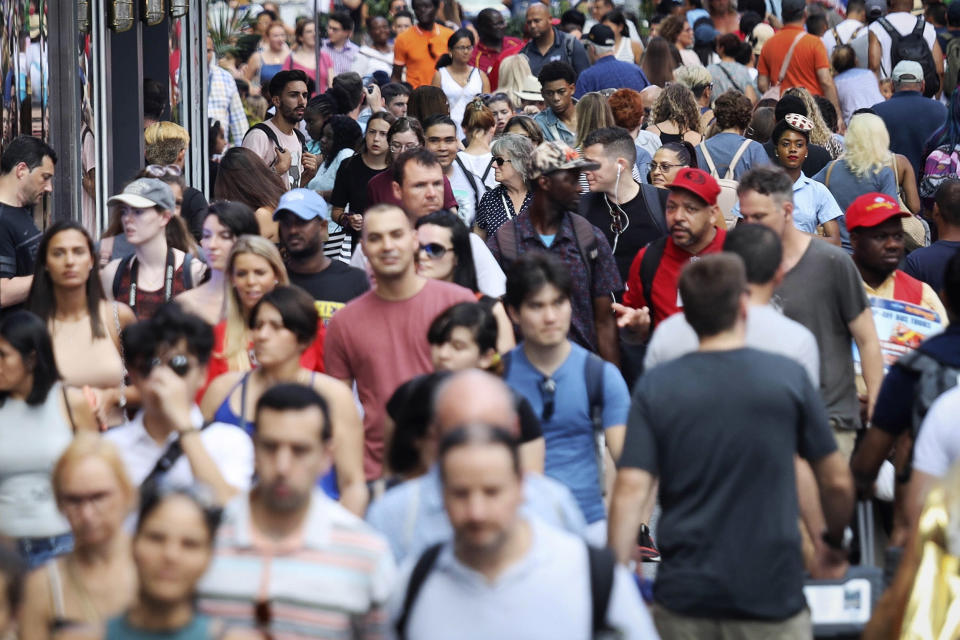 Image: People walk through New York's Times Square. (Bebeto Matthews / AP file)