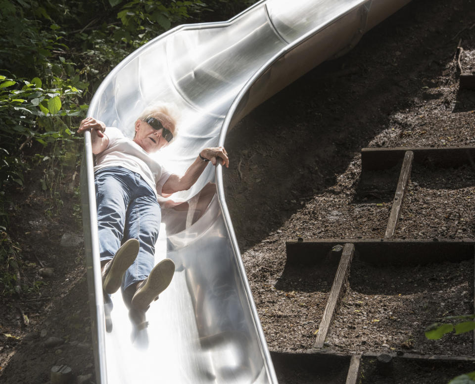 old lady going down a slide