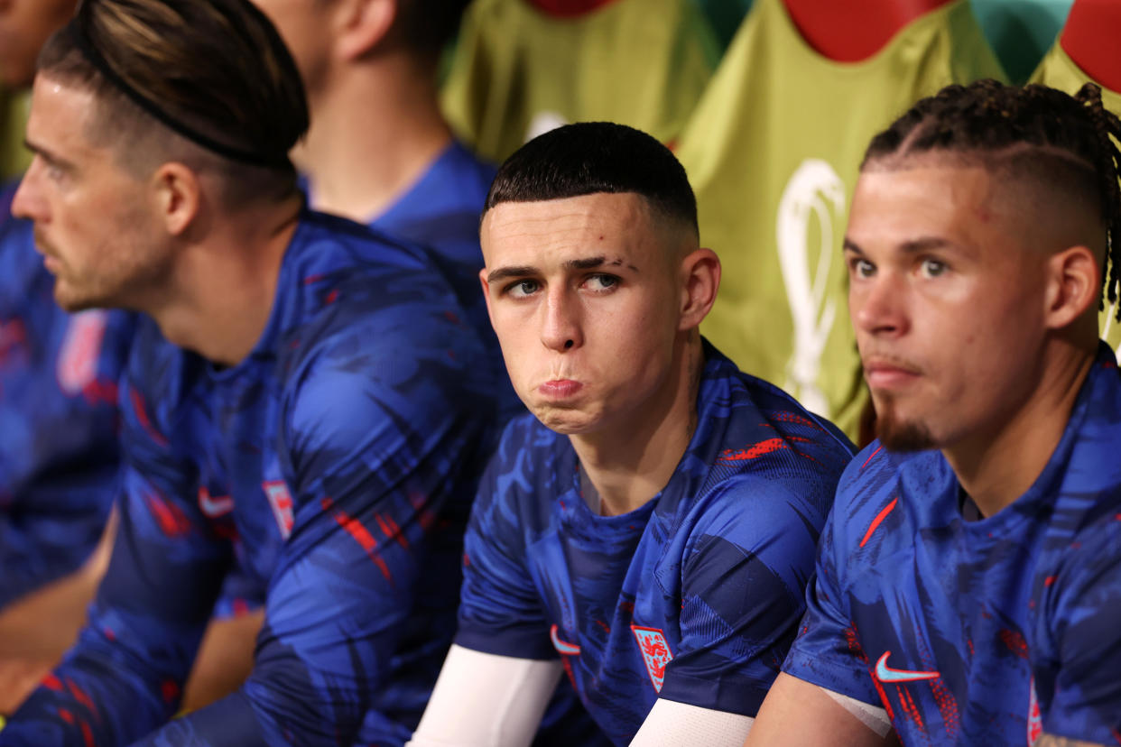 England forward Phil Foden (centre) in the dugout during the World Cup Group B match against the United States.