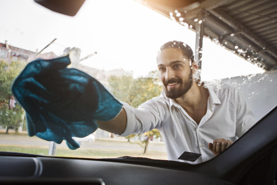 gas station attendant cleaning window