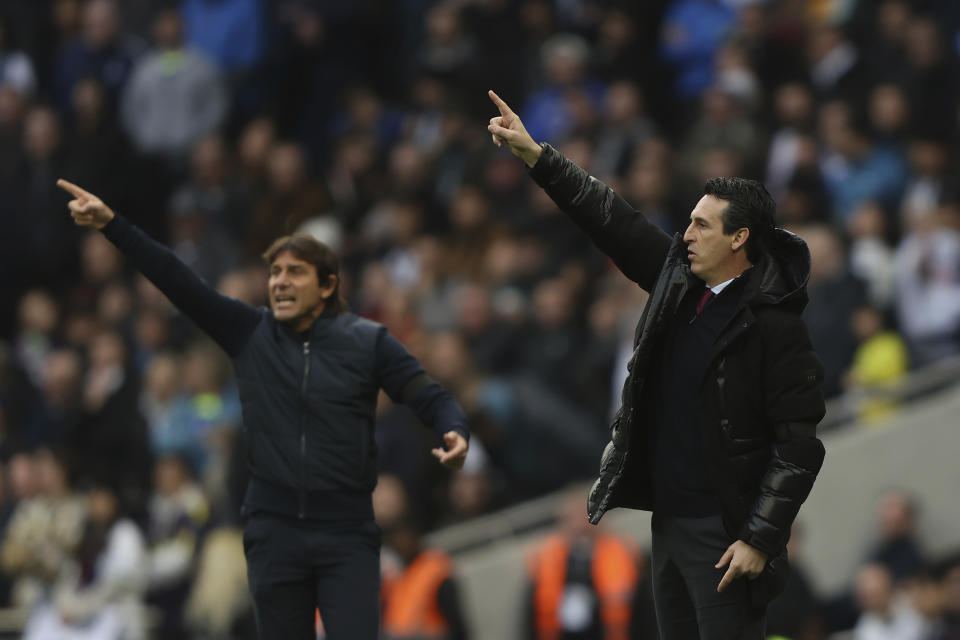 Tottenham's head coach Antonio Conte, left, and Aston Villa's head coach Unai Emery react during the English Premier League soccer match between Tottenham Hotspur and Aston Villa at Tottenham Hotspur Stadium in London, Sunday, Jan. 1, 2023. (AP Photo/Ian Walton)