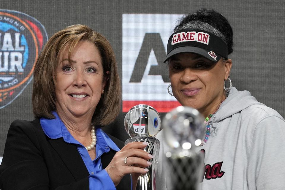 AP's Nancy Nussbaum poses for a photo with South Carolina head coach Dawn Staley after giving her the AP NCAA Women's Coach of the Year award Thursday, April 4, 2024, in Cleveland. (AP Photo/Morry Gash)