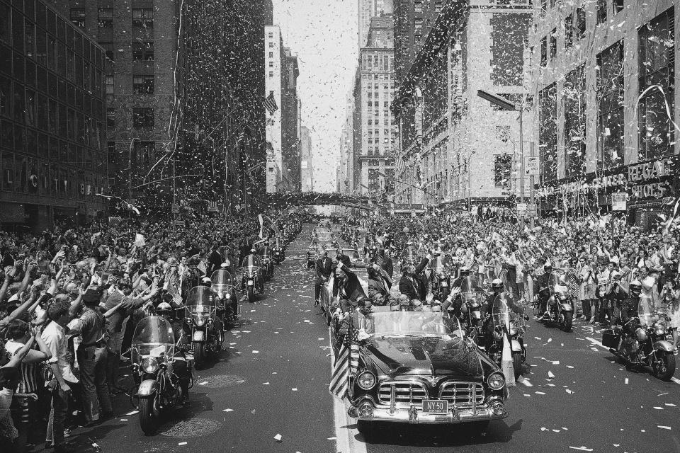 FILE - In this Aug. 13, 1969 file photo, people line 42nd Street in New York to cheer Apollo 11 astronauts, in lead car from left, Buzz Aldrin, Michael Collins and Neil Armstrong, traveling east on 42nd street, towards the United Nations. (AP Photo/File)