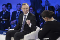 Poland's President Andrzej Duda, left, speaks to Hungary's President Katalin Novák during the 54th annual meeting of the World Economic Forum, WEF, in Davos, Switzerland, Wednesday, January 17, 2024. (Gian Ehrenzeller/Keystone via AP)