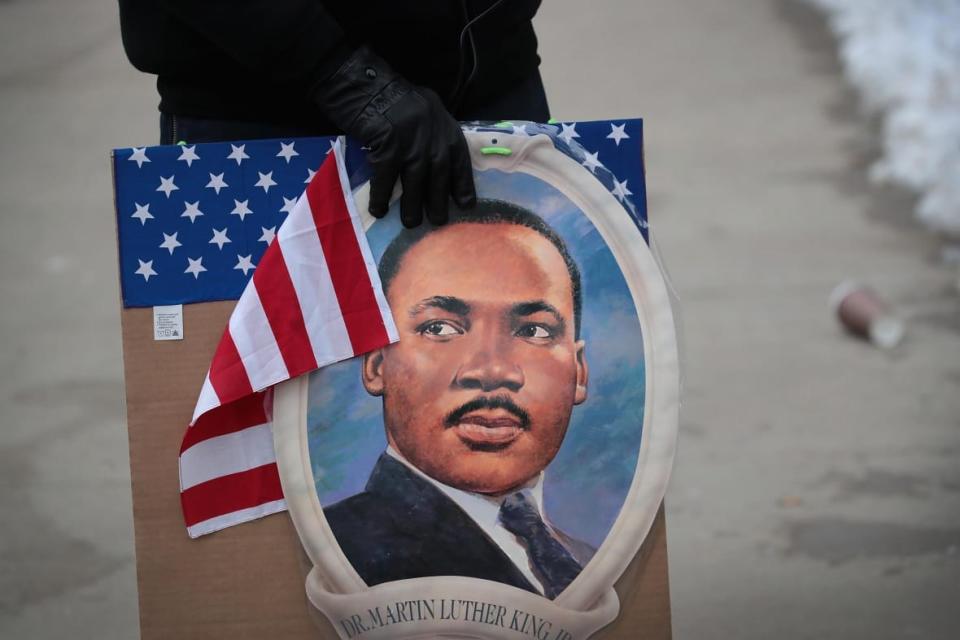 An activist holds a Martin Luther King Jr. sign as they protest outside of the sentencing hearing for former Chicago police officer Jason Van Dyke at the Leighton Criminal Courthouse on January 18, 2019 in Chicago, Illinois. Van Dyke was sentenced to 81 months in prison for the murder of 17-year-old Laquan McDonald. (Photo by Scott Olson/Getty Images)