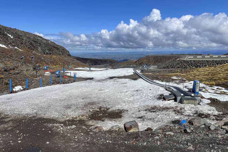 The learners' slope is almost devoid of snow at the Tūroa ski field on Mt. Ruapehu, New Zealand on Sept. 21, 2022. A disastrous snow season has left two of New Zealand's largest ski fields on the brink of bankruptcy, with climate change appearing to play a significant role. (AP Photo/Nick Perry)