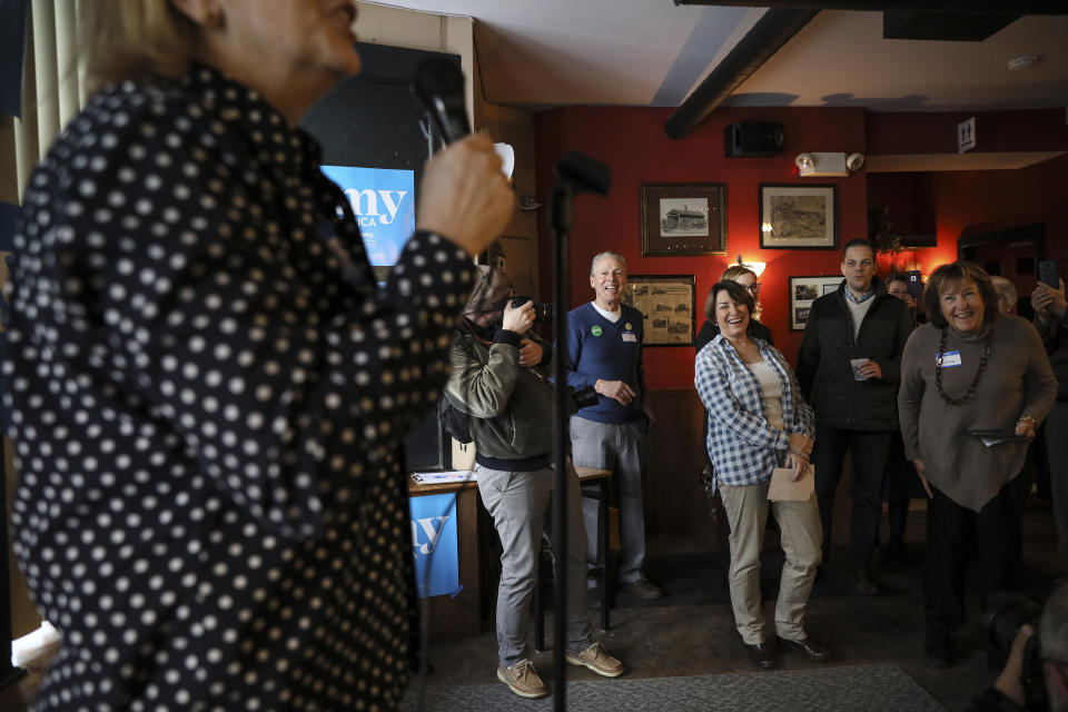 Sen. Amy Klobuchar, D-Minn., third from right, laughs during her introduction during a campaign stop at The Village Trestle in Goffstown, N.H., Monday, Feb. 18, 2019. (AP Photo/Cheryl Senter)