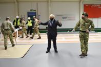 Britain's Prime Minister Boris Johnson meets troops as they set up a vaccination centre in the Castlemilk district in Glasgow, Scotland on January 28, 2021, during a COVID-19 related visit to the country. - Prime Minister Boris Johnson headed to Scotland on Thursday to praise the United Kingdom's collective response to coronavirus, in a bid to counter record support for independence. (Photo by Jeff J Mitchell / POOL / AFP) (Photo by JEFF J MITCHELL/POOL/AFP via Getty Images)