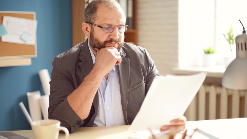 Mature Adult man working in the office.