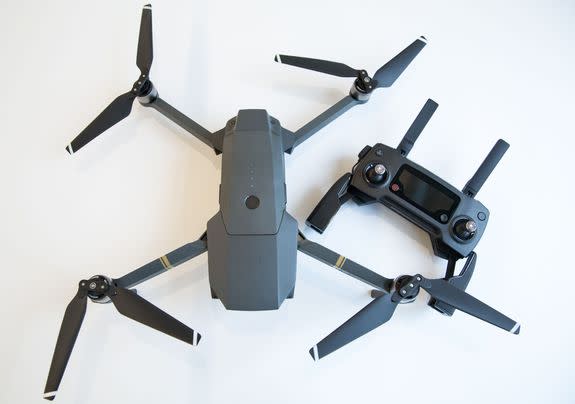 The Mavic Pro unfolded with its remote by its side.