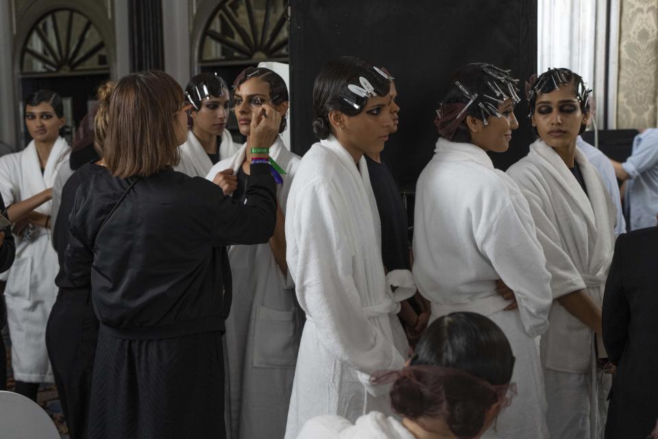 A model has makeup applied backstage prior to the Dior pre-fall 2023 collection show in Mumbai, India, Thursday, March 30, 2023. (AP Photo/Rafiq Maqbool)