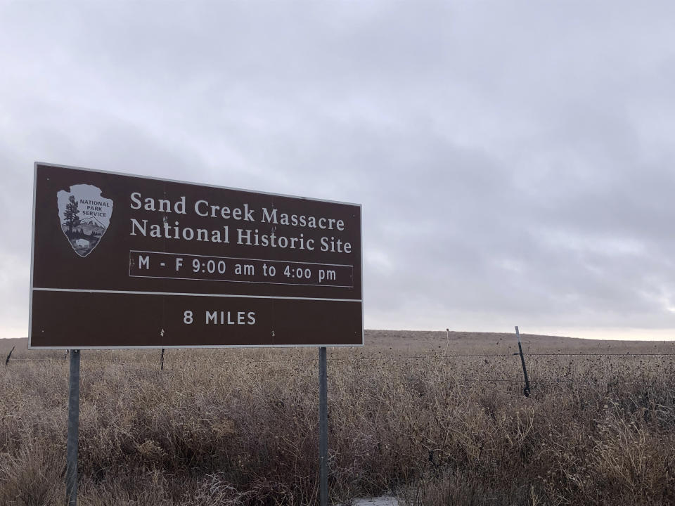 In this Dec. 27, 2019, photo, an entrance sign is shown at the Sand Creek Massacre National Historic Site in Eads, Colo. This quiet piece of land tucked away in rural southeastern Colorado seeks to honor the 230 peaceful Cheyenne and Arapaho tribe members who were slaughtered by the U.S. Army in 1864. It was one of worst mass murders in U.S. history. (AP Photo/Russell Contreras)