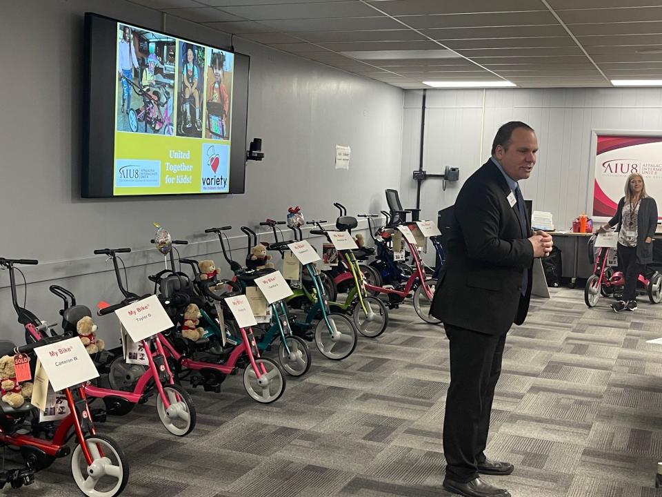 Tom Baker, CEO of Variety, the Children's Charity, speaks to the children's parents during the April 4 bike presentation. Standing in the background is Kara Madara with Appalachia IU8.