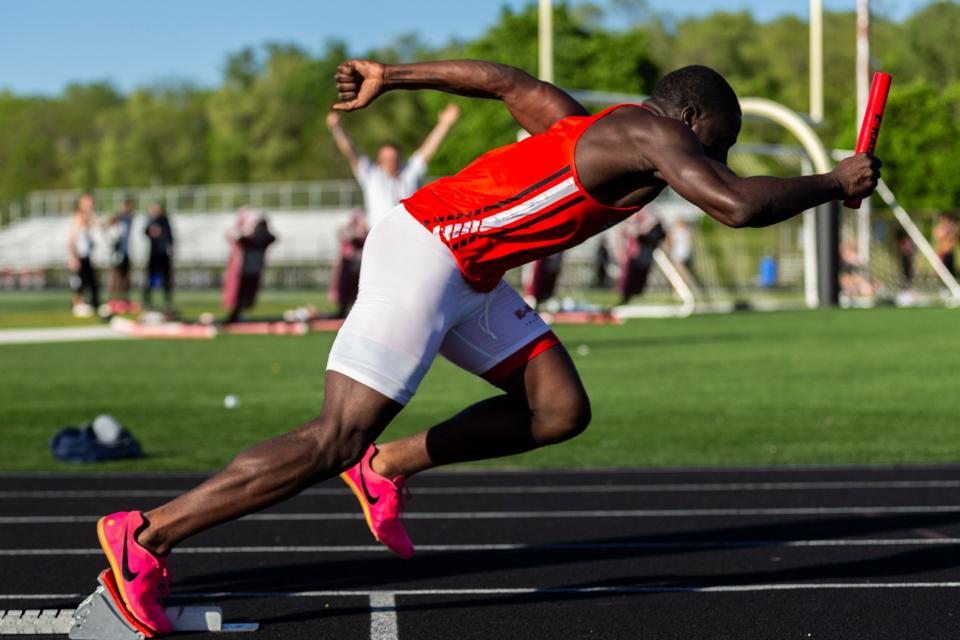 Rockford East sprinter Mechai Docket-Lewis begins the 4x100 relay at the boys NIC-10 conference meet on Friday, May 10, 2024, at Auburn High School.
