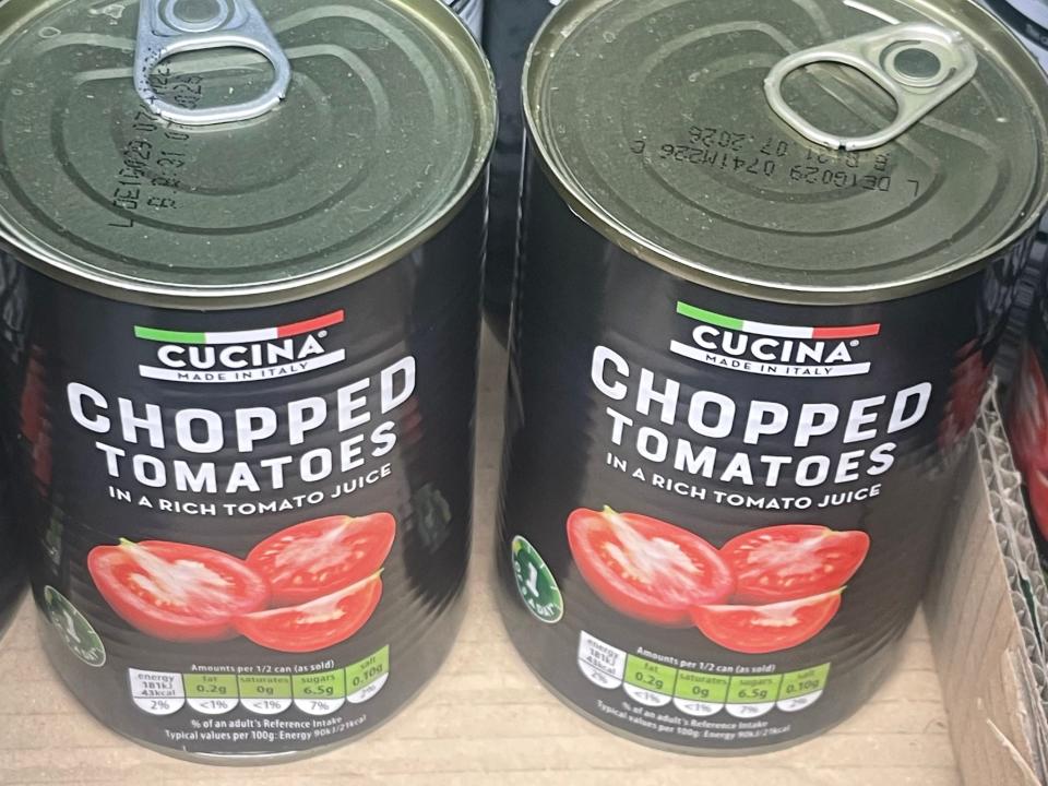cans of chopped tomatoes on the shelves at aldi