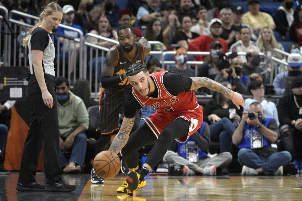 Chicago Bulls guard Lonzo Ball (2) gains control of the ball in front of Orlando Magic guard Terrence Ross (31) during the first half of an NBA basketball game, Friday, Nov. 26, 2021, in Orlando, Fla. (AP Photo/Phelan M. Ebenhack)