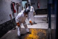 Los trabajadores comprueban que todo el proceso se está desarrollando con normalidad durante la cremación de un fallecido. (Photo by PEDRO PARDO/AFP via Getty Images)