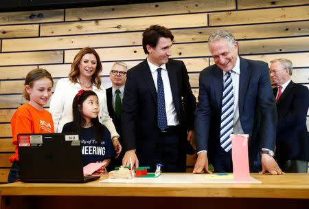 Canada's Prime Minister Justin Trudeau and Sidewalk Labs CEO Dan Doctoroff (R) smile as they look at city models built by children before a press conference where Alphabet Inc, the owner of Google, announced the project "Sidewalk Toronto", that will develop an area of Toronto's waterfront using new technologies to develop high-tech urban areas in Toronto, Ontario, Canada October 17, 2017. REUTERS/Mark Blinch