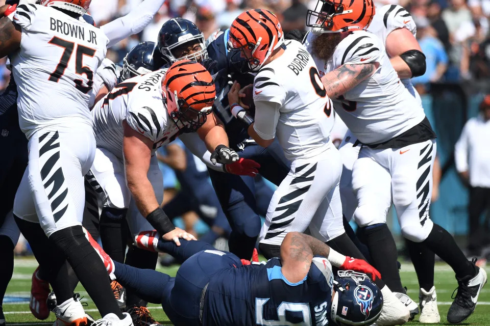 Oct 1, 2023; Nashville, Tennessee, USA; Cincinnati Bengals quarterback Joe Burrow (9) is sacked by Tennessee Titans defensive tackle Jeffery Simmons (98) during the first half at Nissan Stadium.