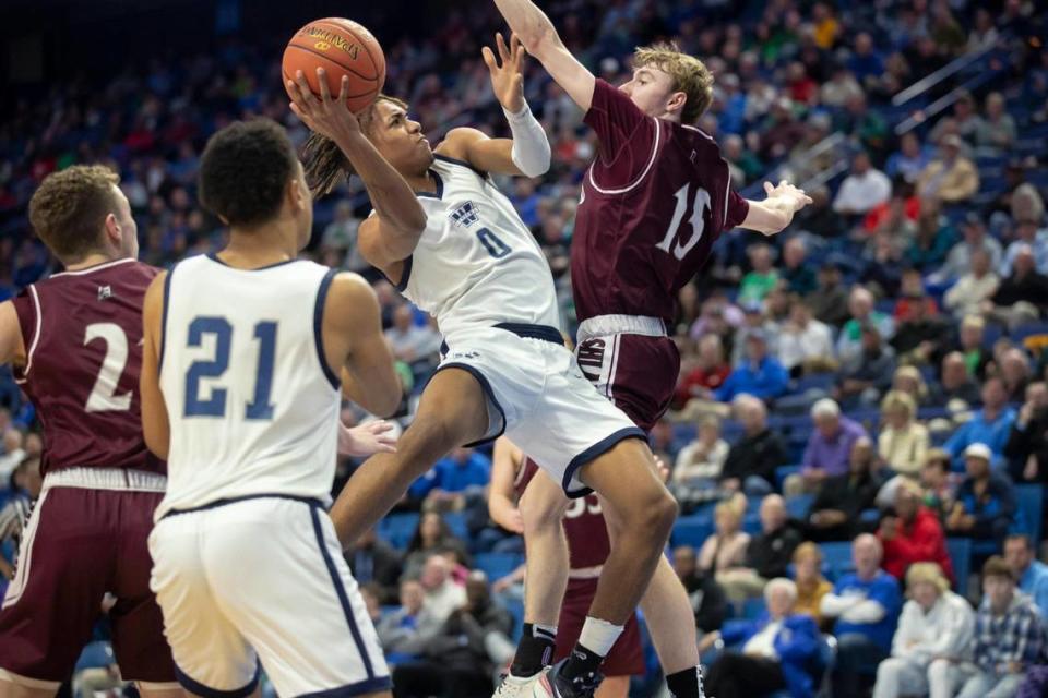 Warren Central’s Damarion Walkup (0) tries to shoot over Ashland Blazer’s Tucker Conway (15) during Friday’s state tournament quarterfinal in Rupp Arena.