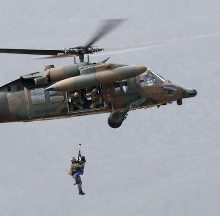 A local resident is rescued by a Japan Self-Defence Force helicopter from residential areas flooded by the Chikuma river, caused by Typhoon Hagibis in Nagano