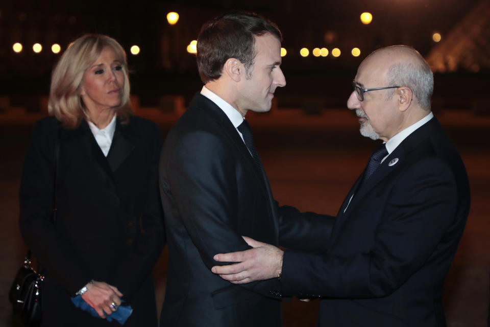 CRIF president Francis Kalifat, right, welcomes France's President Emmanuel Macron and his wife Brigitte Macron at the Louvre Carrousel as they arrive to attend the 34rd annual dinner of the group CRIF, Representative Council of Jewish Institutions of France, in Paris, Wednesday, Feb. 20, 2019. (Ludovic Marin, Pool Photo via AP)