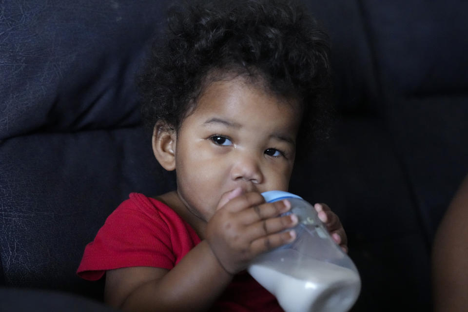 Olivia Yancey, 11 months old, drinks formula made from non dairy milk Thursday, Dec. 14, 2023, in Douglasville, Ga. More than 6 million people in the U.S. get benefits from the Special Supplemental Nutrition Program for Women and Children, commonly known as WIC. But it’s not always easy to get the fresh produce, baby formula and other nutritious WIC-approved items. (AP Photo/John Bazemore)