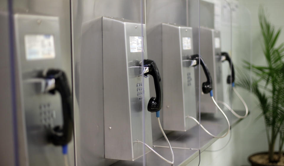 A bank of phones are seen at the Karnes County Residential Center, Thursday, July 31, 2014, in Karnes City, Texas. Federal officials gave a tour of the immigration detention facility that has been retooled to house adults with children who have been apprehended at the border. As Thursday, Feb. 22, 2024, cell phone outage shows, sometimes landline telephones can come in handy, and were suggested as part of the alternatives when people's cell phones weren't working. (AP Photo/Eric Gay)