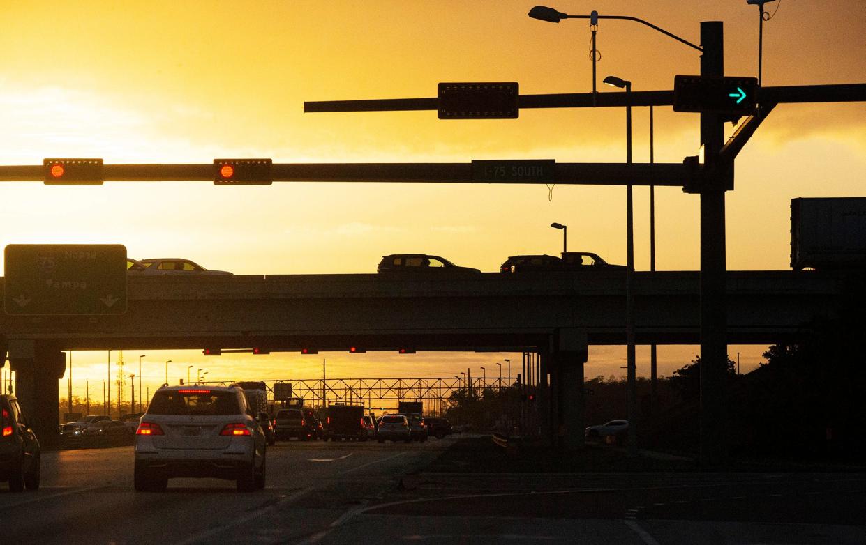 The sun rises over I-75 at the State Road 82 intersection as traffic moves on the busy roadway on Thursday, Feb. 16, 2023.