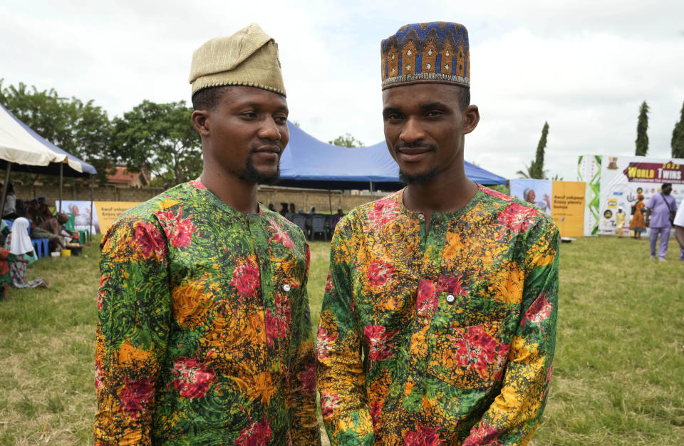 Twins Taiwo Ojeniyi, left, and Kehinde Ojeniyi, 27, attends the annual twins festival in Igbo-Ora South west Nigeria, Saturday, Oct. 8, 2022. The town holds the annual festival to celebrate the high number of twins and multiple births. (AP Photo/Sunday Alamba)