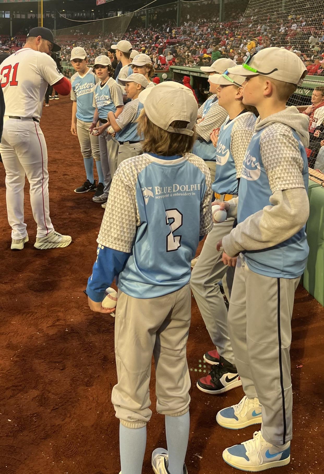 The Exeter Cal Ripken team of 12-and-under baseball players made an appearance on the field at Fenway Park in Boston, shaking hands with Red Sox players, Wednesday, April 17, 2024.