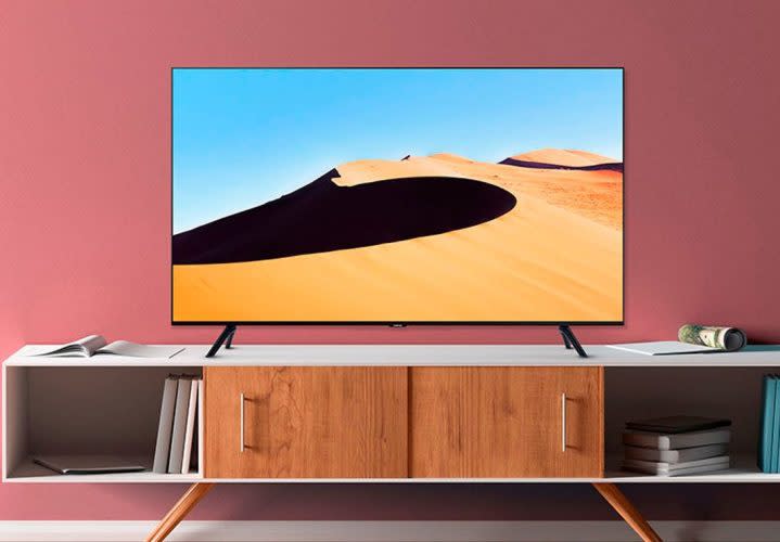 The Samsung TU69OT 4K Smart TV on a media cabinet in a living room.