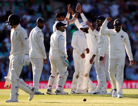 Cricket - England v India - Fifth Test - Kia Oval, London, Britain - September 7, 2018 India's Ishant Sharma celebrates the wicket of England's Sam Curran with teammates Action Images via Reuters/Paul Childs