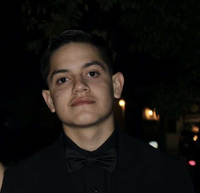Anthony Reyes Jr dressed in a black suit. 