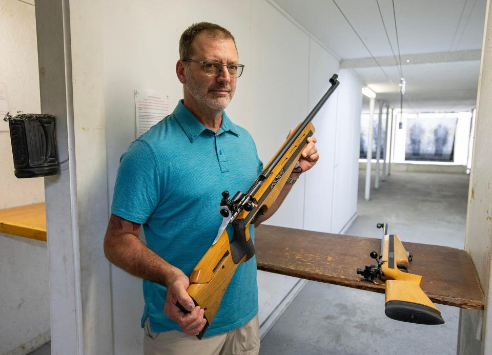 Vinny Amatucci holds an Anschutz competition rifle used in the junior marksmanship program Thursday in the indoor range at the Marlborough Fish & Game Association.