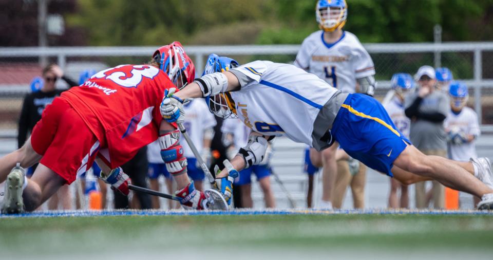 Fairport's Corey Roeser and Irondequoit's Jonah Carrier duel on a faceoff.