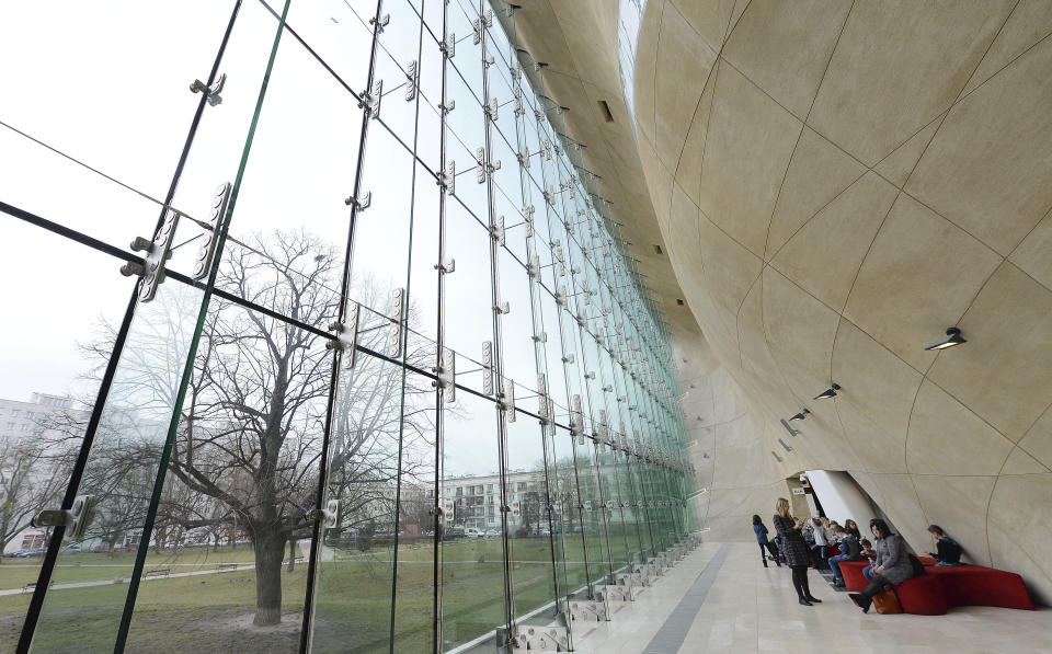 People visit the POLIN Museum of the History of Polish Jews in Warsaw, Poland, Wednesday, Feb. 12, 2020. A long stalemate over the future independence of the landmark Jewish history museum is building toward a crucial turning point after the former director — who won a competition for a second term but whom Poland's populist government refuses to reinstate — offered to renounce the job.(AP Photo/Czarek Sokolowski)