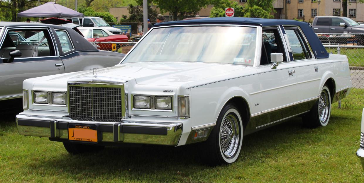 A white 1986 Lincoln Town Car photographed during at a classic car show, in Merrick, New York, USA