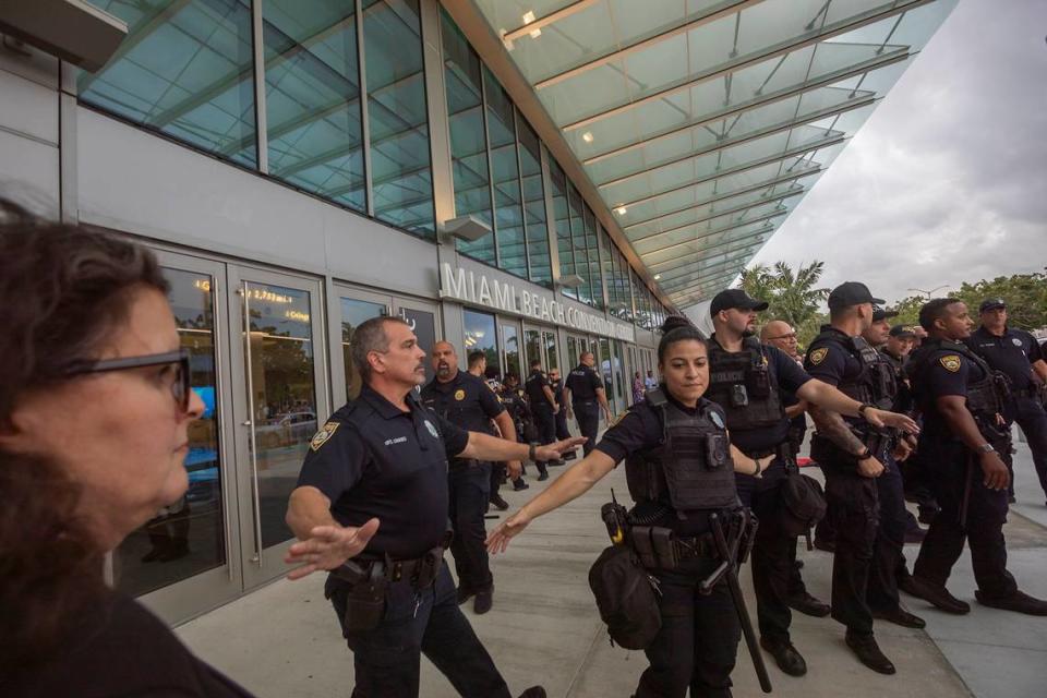 Miami Beach Police keeping pro-Palestine protesters away from the Miami Beach Convention Center doors at a protest during Art Basel.