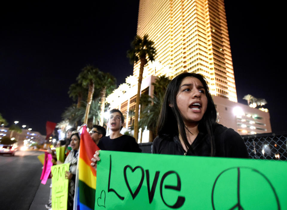 Demonstrators carry placards in protest against the election of Republican Donald Trump as president of the United States, near the Trump International Hotel &amp; Tower in Las Vegas, U.S. Nov. 9, 2016. REUTERS/David Becker