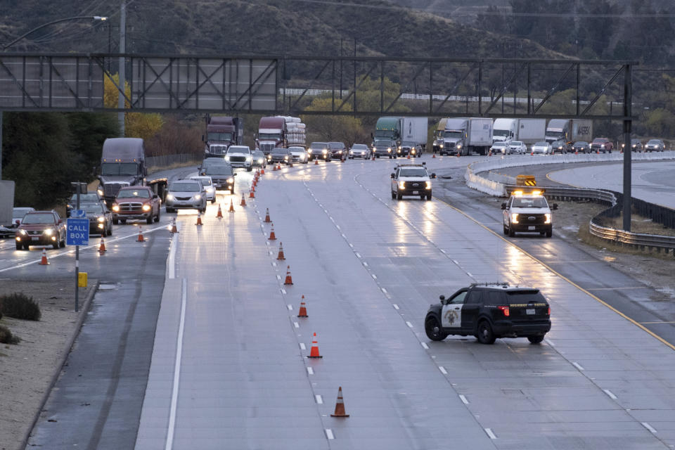 Traffic on the northbound side of the I-5 freeway is diverted off at Parker road in Castaic, Calif., as snow on the Grapevine has made the road impassable Thursday, December 26, 2019. The CHP had no estimate as to when the freeway would re-open. (David Crane/The Orange County Register via AP)