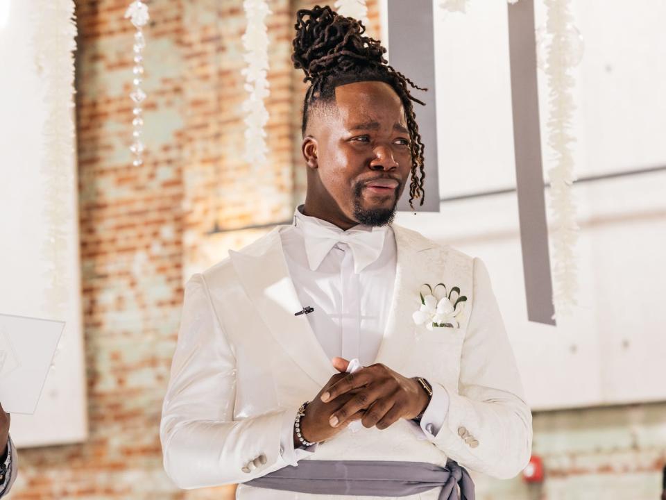 A groom cries as his bride walks down the aisle.